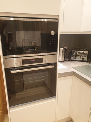 A kitchen with a Bosch oven, a toaster, and a sink.