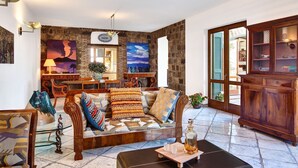 A cozy living room with a sofa, a coffee table, and a cabinet. There is a dining area with a table and chairs. - Beautiful private villa with A/C, private pool, WIFI, TV, patio, panoramic view, close to Sorrento (Sant'agata Sui Due Golfi)