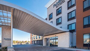 A Fairfield by Marriott hotel with a modern design, featuring a covered entrance and multiple windows.