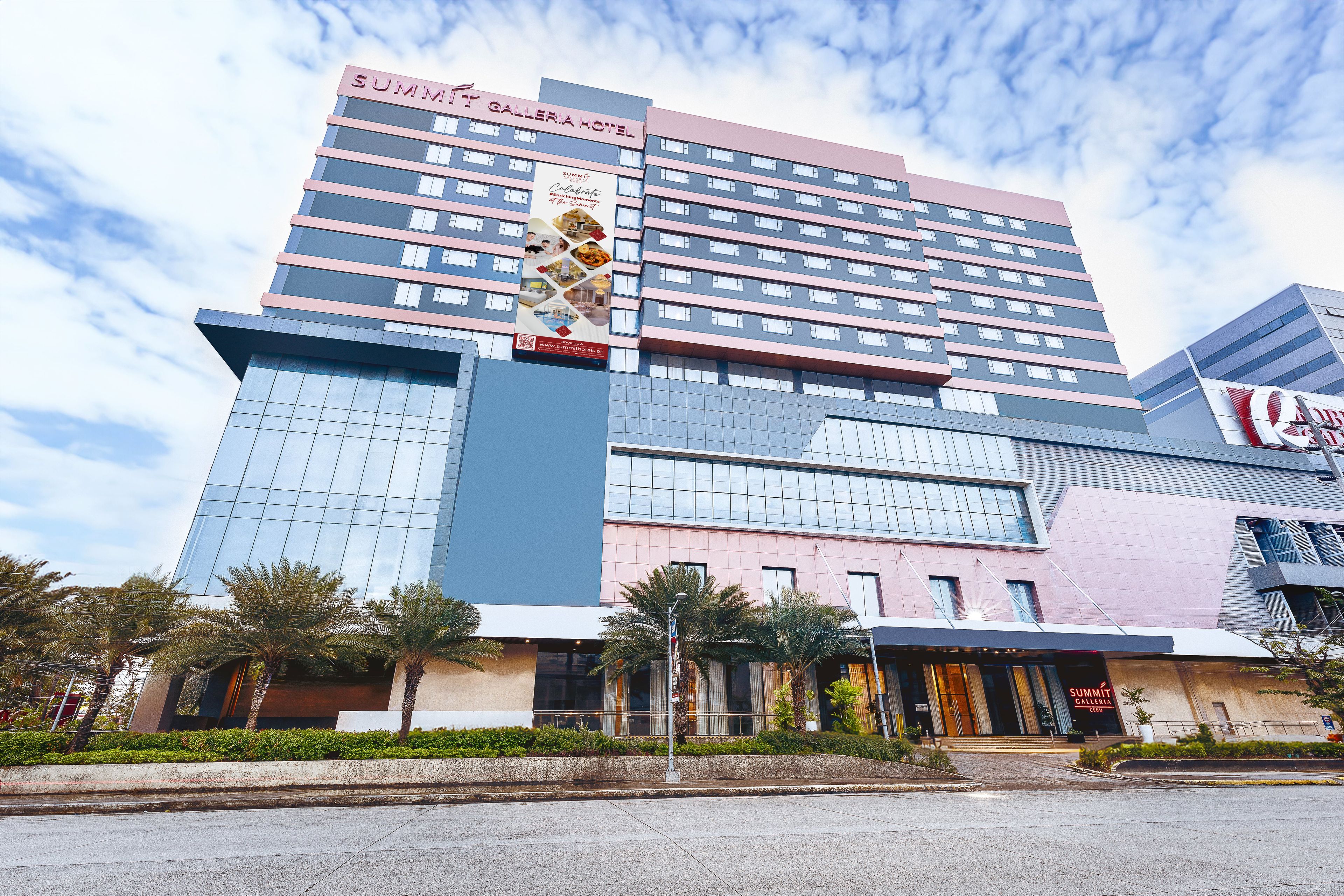 A multi-story hotel with a prominent 'Summit Plaza Hotel' sign, featuring a modern architectural design with glass and metal elements.