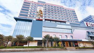 A multi-story hotel with a prominent 'Summit Plaza Hotel' sign, featuring a modern architectural design with glass and metal elements.