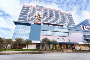 A multi-story hotel with a prominent 'Summit Plaza Hotel' sign, featuring a modern architectural design with glass and metal elements.