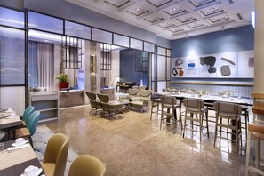A modern conference room with a large table, multiple chairs, and a decorative wall with abstract art. - Summit Galleria Cebu (Cebu City)