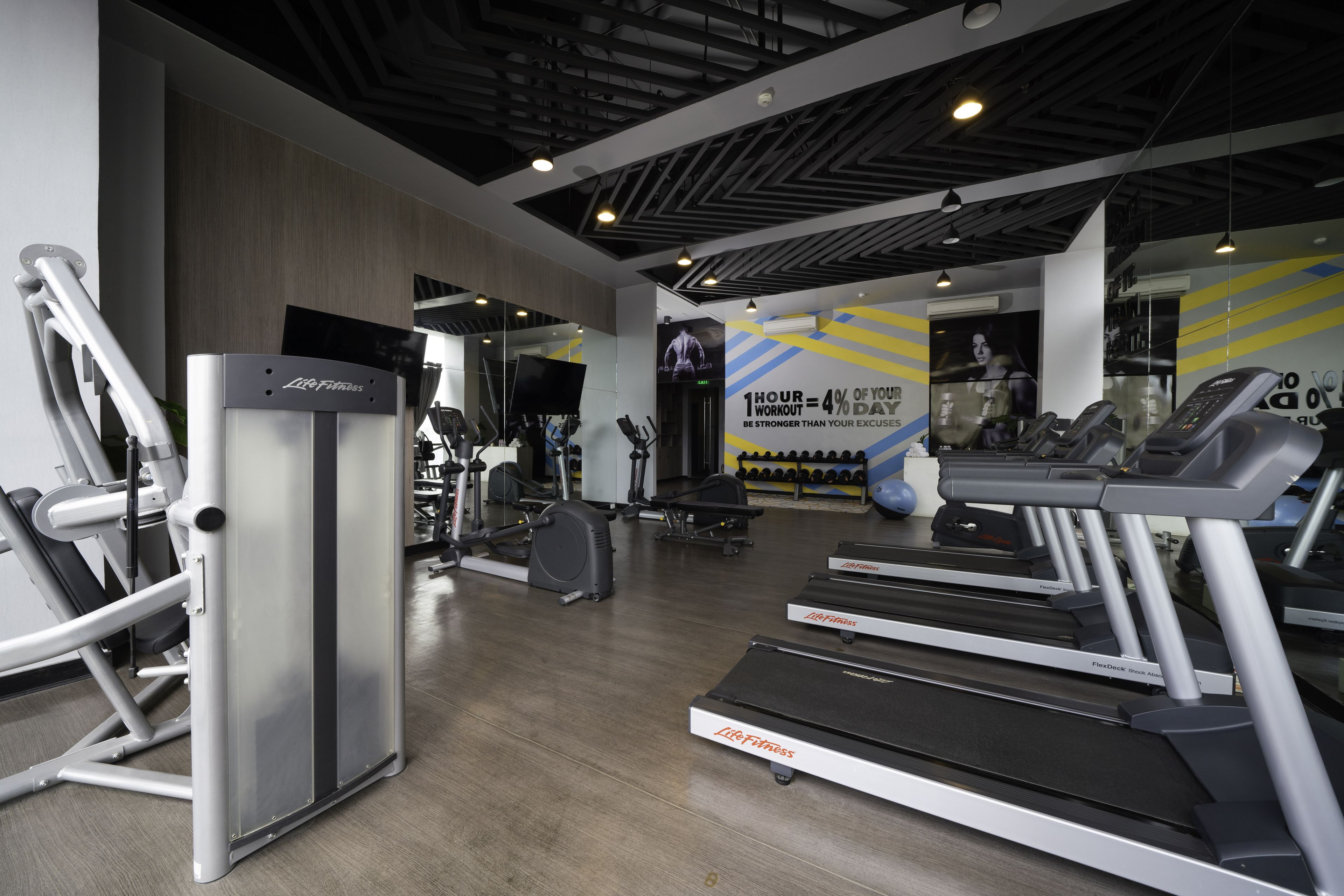 A gym with treadmills, elliptical machines, and weight equipment.