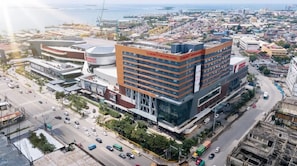 A modern hotel with multiple floors, a prominent sign, and a view of the surrounding cityscape. - Summit Galleria Cebu (Cebu City)
