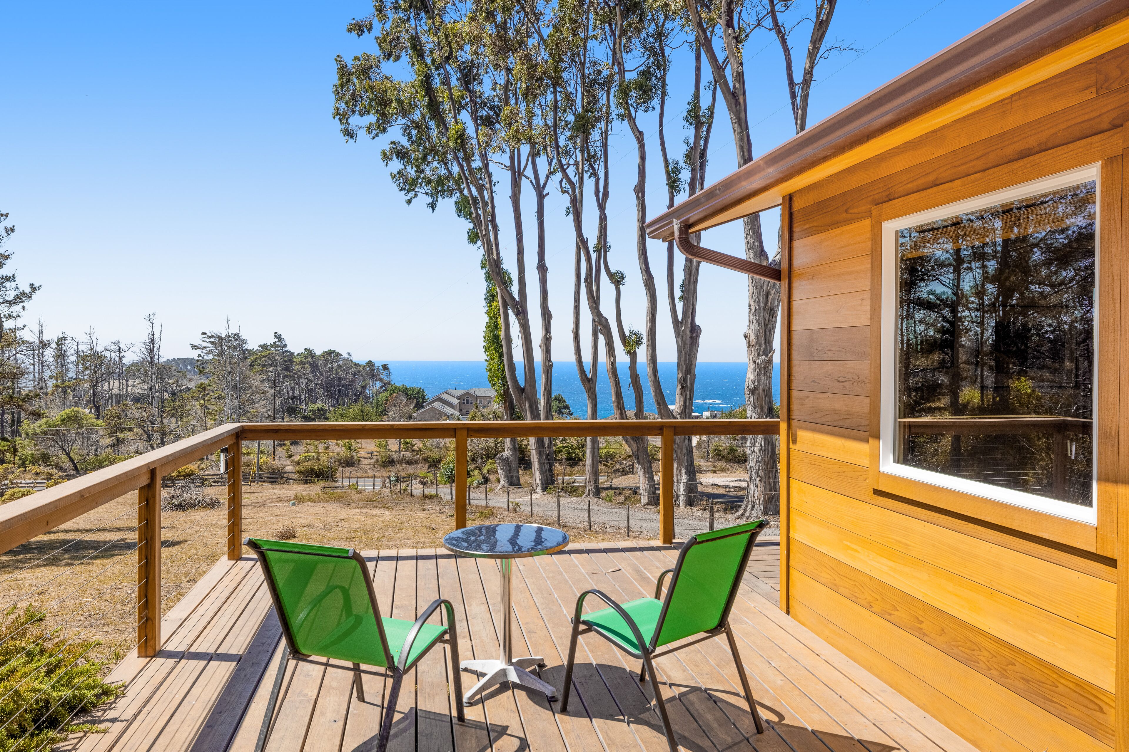 Lower-level cottage with ocean views, fireplace, furnished deck, & internet