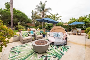 An outdoor patio area with wicker furniture, a fire pit, and umbrellas providing shade. - Private Lux Bungalow - Pool + Spa l
Pet Paradise (Oceanside)