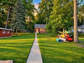 A residential area with a pathway leading to a house, surrounded by trees and a small shed. - The Roadhouse: Lake Views▪Crystal Mountain▪Sleeping Bear Dunes▪Traverse... (Honor)