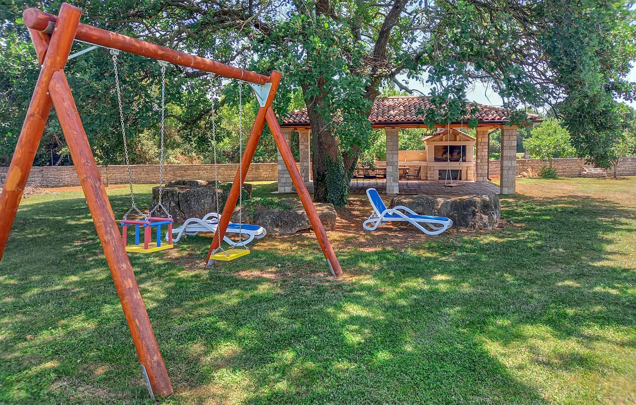 A playground with swings, slides, and a small pavilion.