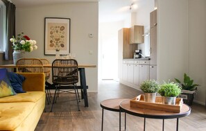 Relax in this inviting living space with a sofa, dining area, and kitchen.