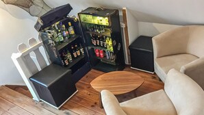 A corner of a room with a beige armchair, a small round wooden table, and two black speakers. - 3 bedroom stunning home in Alt Bukow (Alt Bukow)