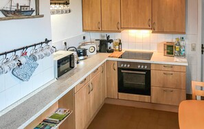 Fridge, stovetop, dishwasher, coffee/tea maker