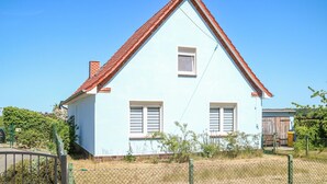 A light blue house with a red roof, two windows with shutters, and a small porch area. - 3 bedroom stunning home in Alt Bukow (Alt Bukow)