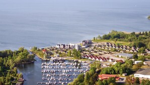 An aerial view of a marina with numerous boats docked, surrounded by residential buildings and greenery. - Amazing home in Rechlin with kitchen (Rechlin)