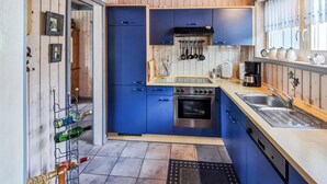 A compact kitchen with blue cabinets, a stainless steel oven, and a sink. - Amazing home in Rechlin with kitchen (Rechlin)