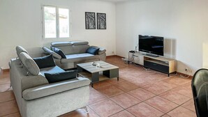 A living room with a grey sofa, a coffee table, a TV, and a cabinet. - Stunning home in Salles d'Aude (Salles d'Aude)