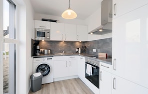 Fridge, stovetop, dishwasher, coffee/tea maker