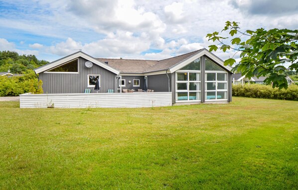 Enjoy a covered seating area and a spacious front porch with a set of stairs.