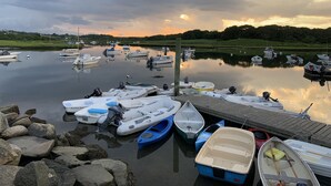 A marina with various boats docked, calm water, and a dock extending into the water. - Newly built house, Central A/C, Walk to ferry, beach, and town (Tisbury)