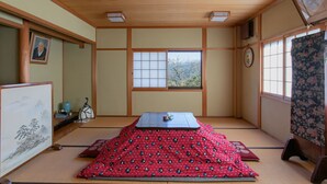 A traditional Japanese room with tatami flooring, a low table, and shoji screens. - Houtouji Temple (Yoshino)