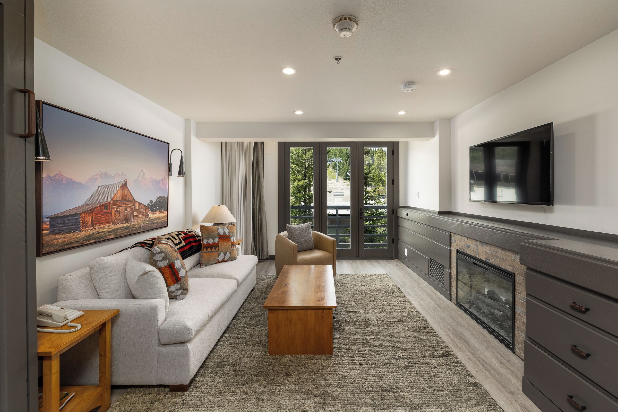 A modern living room with a sofa, coffee table, and a fireplace.