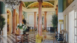 A grand lobby with high ceilings, ornate columns, and a checkered floor. - Queen s Hotel (Portsmouth)