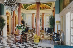 A grand lobby with high ceilings, ornate columns, and a checkered floor. - Queen s Hotel (Portsmouth)