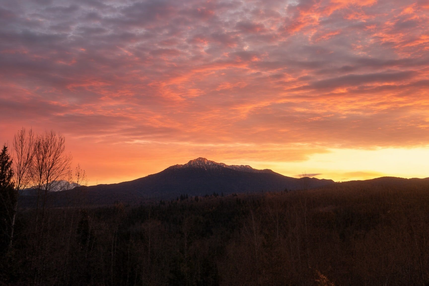 A mountain range with a sunset sky.