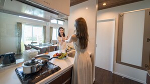 A modern kitchen with a stove, sink, and countertop. - BEVERLY HILLS VILLA Miyakojima Resort (Miyakojima)
