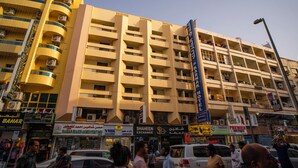 A multi-story hotel with balconies and air conditioning units. - Al Karnak Hotel (Dubai)