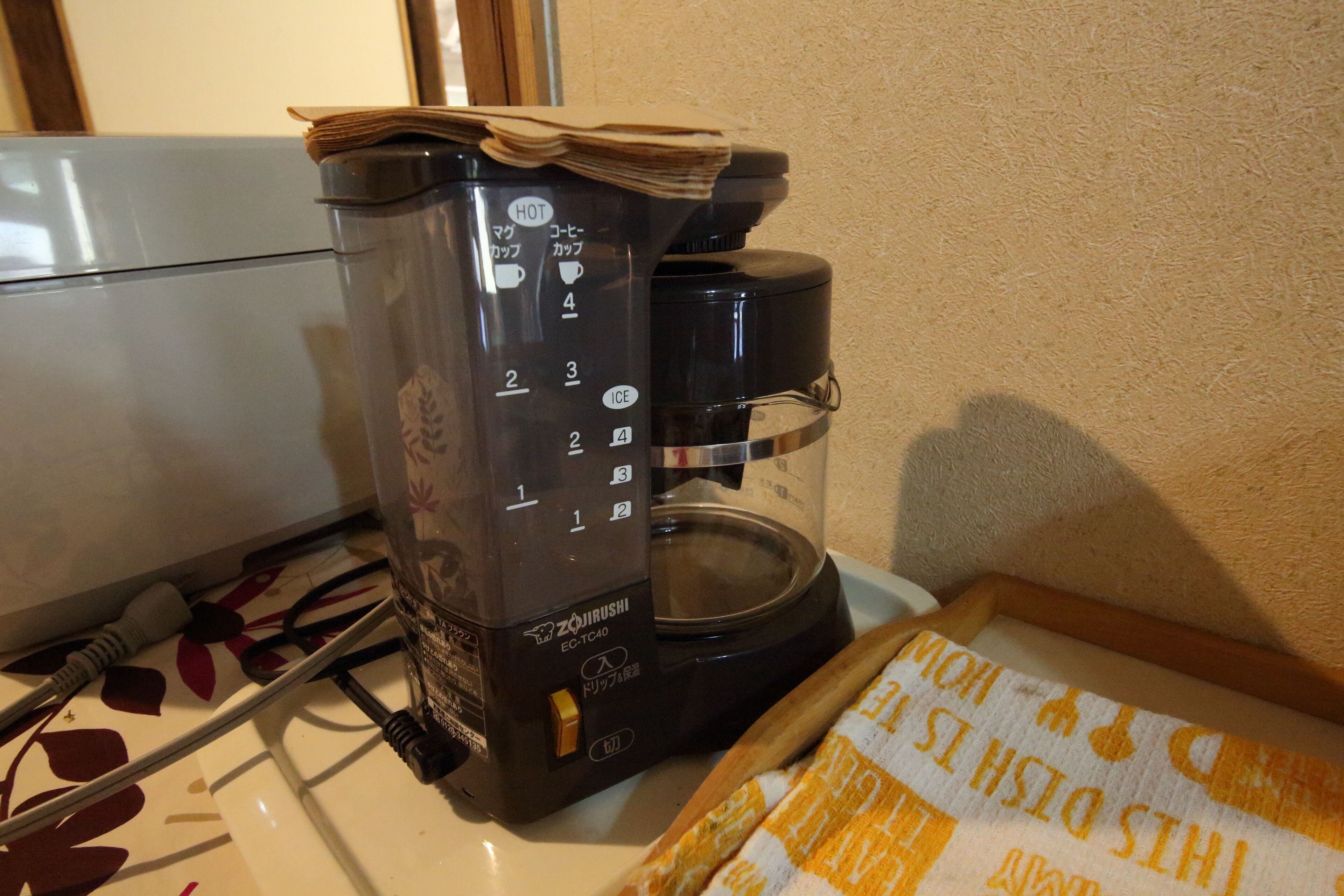 Una cafetera con panel de control y jarra.