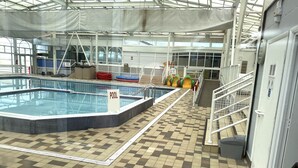 An indoor swimming pool with a checkered floor, a pool sign, and safety railings. - 3 Bed 8 Berth Caravan in California Cliffs - D53 (Great Yarmouth)