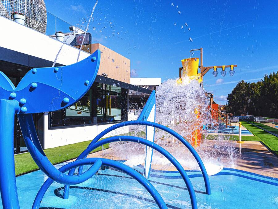 Una fuente ornamental con una escultura azul en un espacio público.