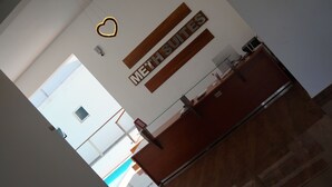 A reception area with a sign reading "MEET SUITES" and a heart-shaped light fixture above it. - Meth Suites (Uswetakeiyawa)