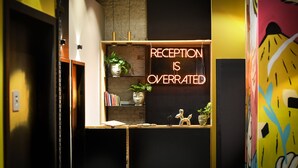 A reception area with a neon sign stating "RECEPTION IS OVERRATED." - Colorbox Ben Yehuda - Smart Hotel by Loginn Tel Aviv (Tel Aviv)