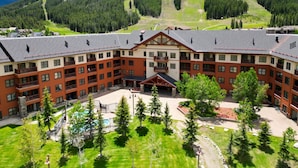 A large hotel with multiple floors, a central courtyard, and a pool. - Amazing Copper Springs Condo With Awesome Views - CS221 by Redawning (Copper Mountain)