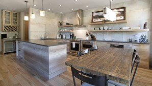 A modern kitchen with a large island, built-in appliances, and pendant lighting. - Sunvail S 24d 3 Bedroom Condo by RedAwning (Vail)
