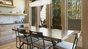 A modern kitchen with a large dining table, built-in cabinets, and a hanging light fixture. - Sunvail S 24d 3 Bedroom Condo by RedAwning (Vail)