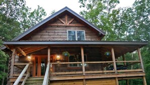 A wooden cabin with a porch, a staircase, and a window. - Rocky Top Retreat-Decorated for Christmas Near NPS (Victor)