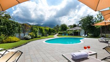 Seasonal outdoor pool, pool umbrellas, pool loungers