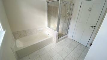 Bathtub, hair dryer, towels, shampoo