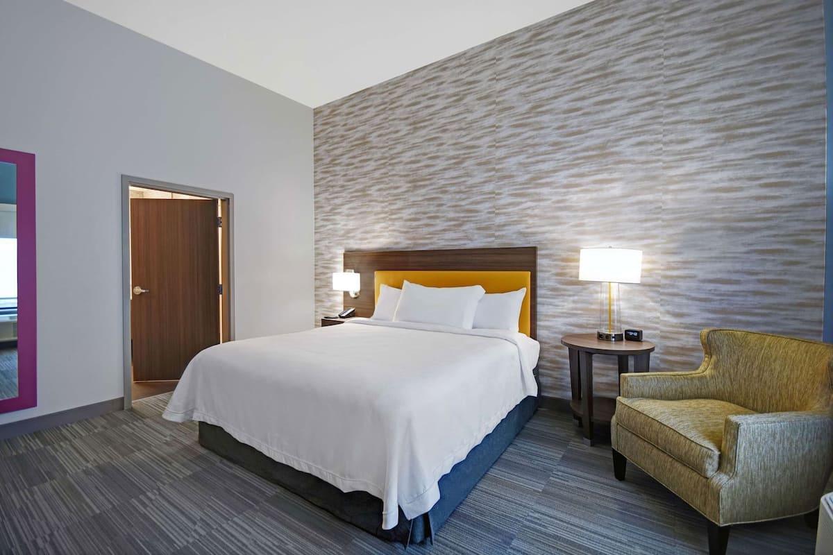 Hypo-allergenic bedding, desk, laptop workspace, blackout curtains