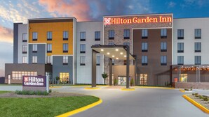 A Hilton Garden Inn with a modern design, featuring a prominent entrance and a well-lit facade.