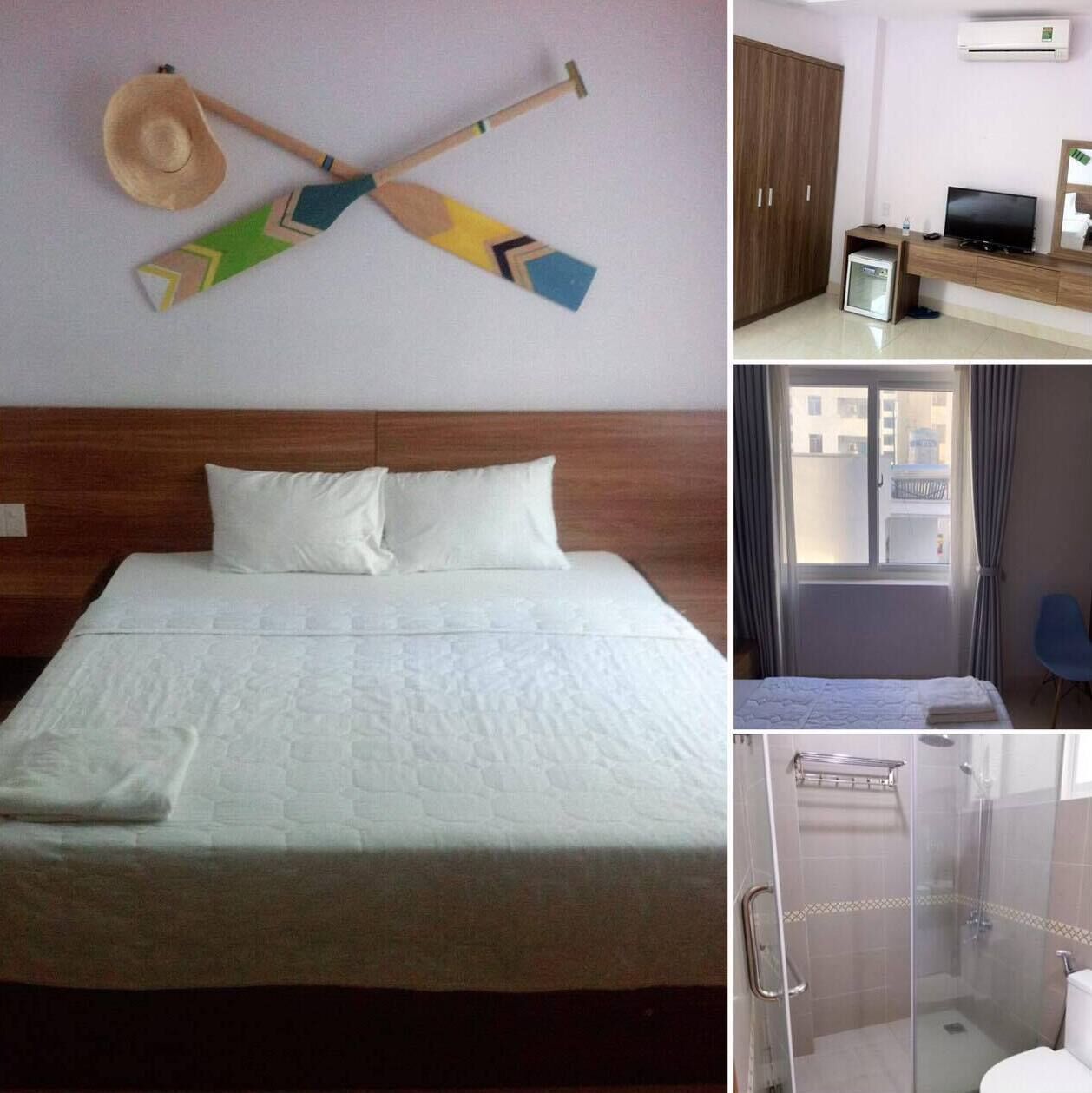 A hotel room with a bed, a TV, a wardrobe, and a shower area.