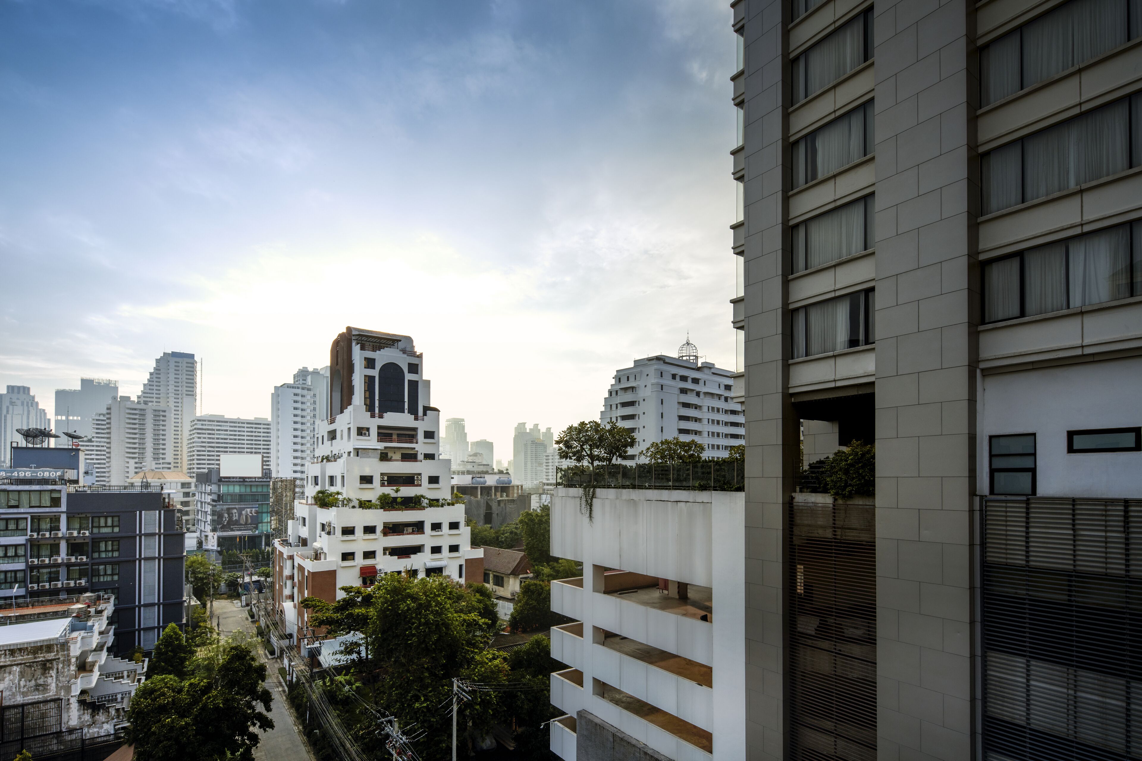 A high-rise building with multiple balconies and a modern architectural design.