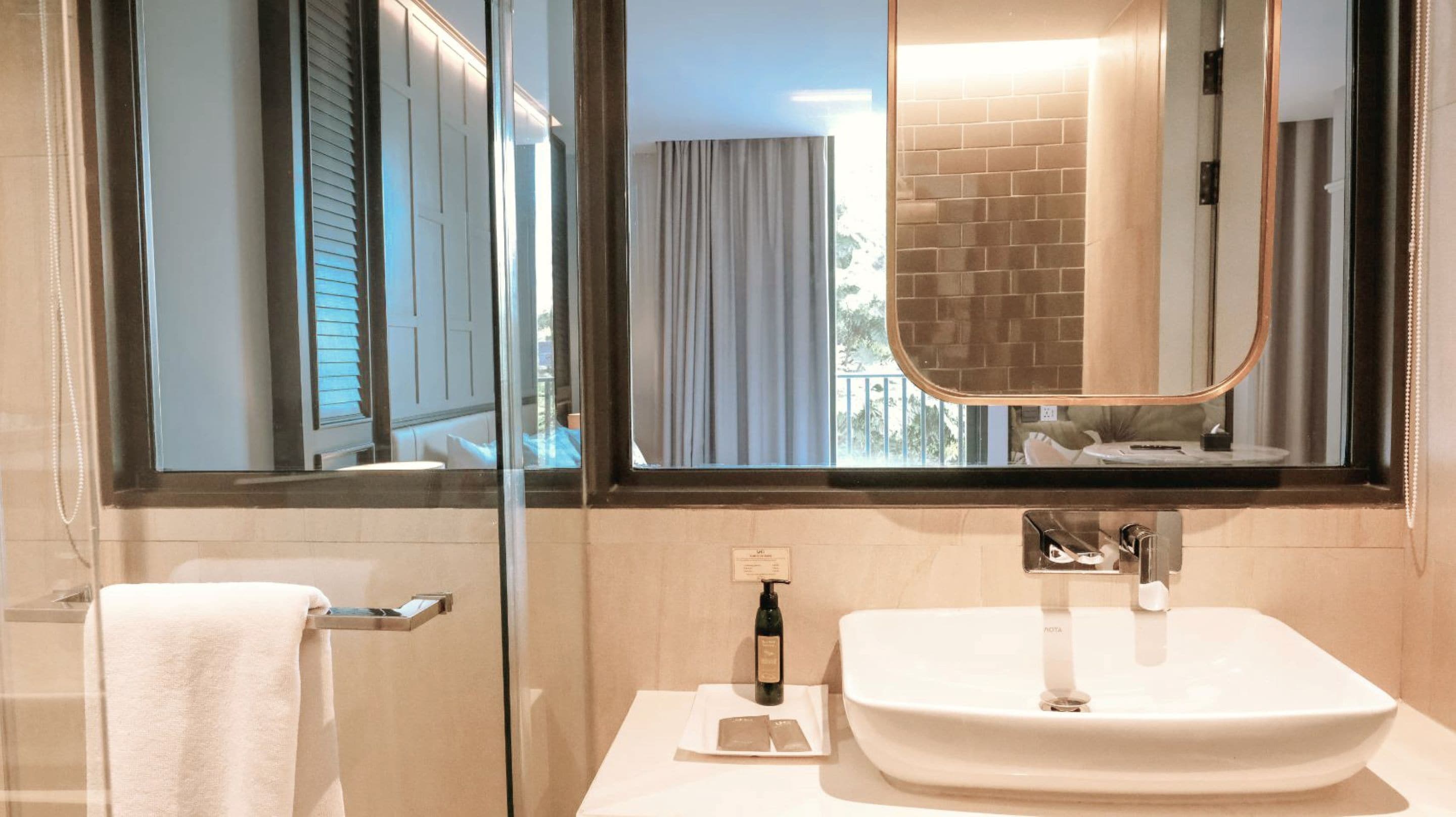 deluxe corner | bathroom | shower, rainfall showerhead, hair dryer, towels