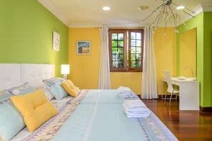 A hotel room with a bed, a desk, and a window with curtains. - Beachfront Ground-Floor Villa w/ Pool & BBQ (Playa Honda)