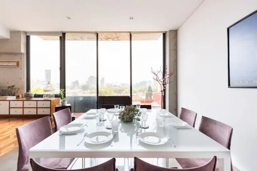 Loft in fifth floor with great views to green and the city and a roof garden too