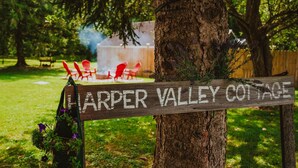 A wooden sign with the text "HARPER VALLEY COTTAGE" attached to a tree. - Pet-friendly, renovated, walk to downtown. (Nashville)