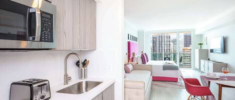 A modern kitchen with a microwave, toaster, and sink.